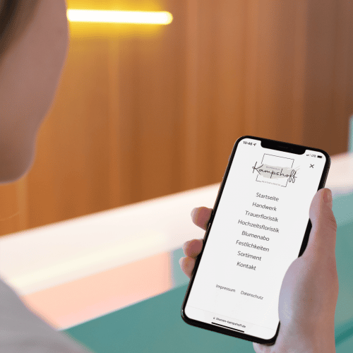 mockup-of-a-girl-holding-an-iphone-xs-max-in-a-bright-corridor-25432